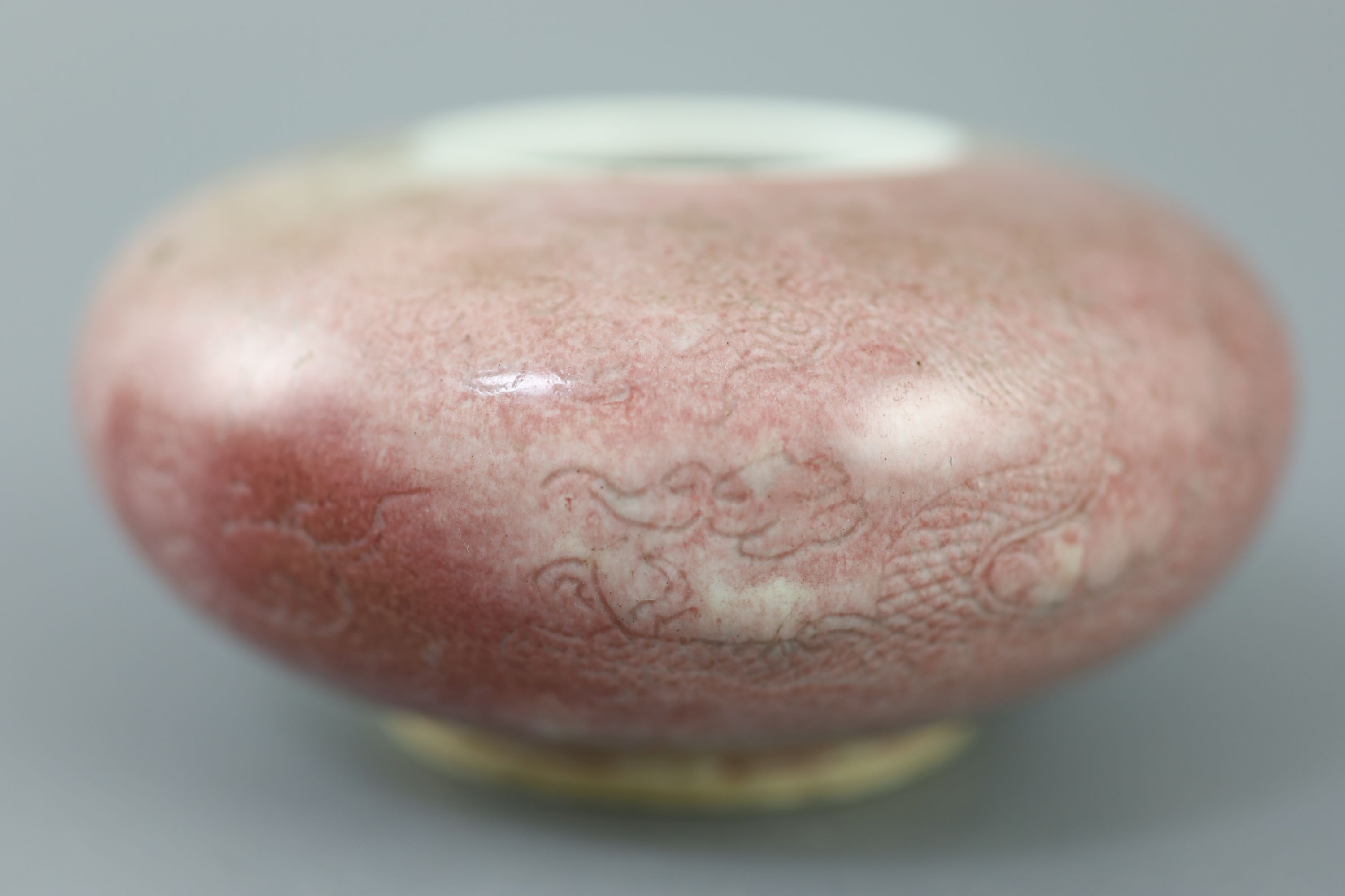 A Chinese peach-bloom dragon water pot, Kangxi six character mark, probably Republic period, 12cm diameter